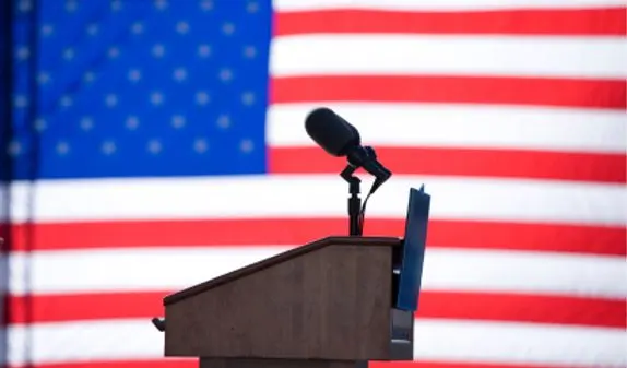 A podium with the American flag in the background