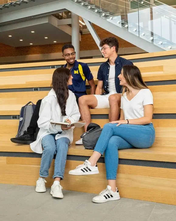 group of students talking on bleachers