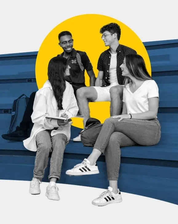 group of four students talking to each other